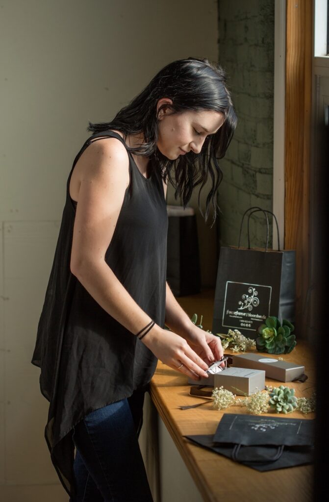 Employee works with dried flowers at Bloombeads Freezeframe Dayton, Ohio