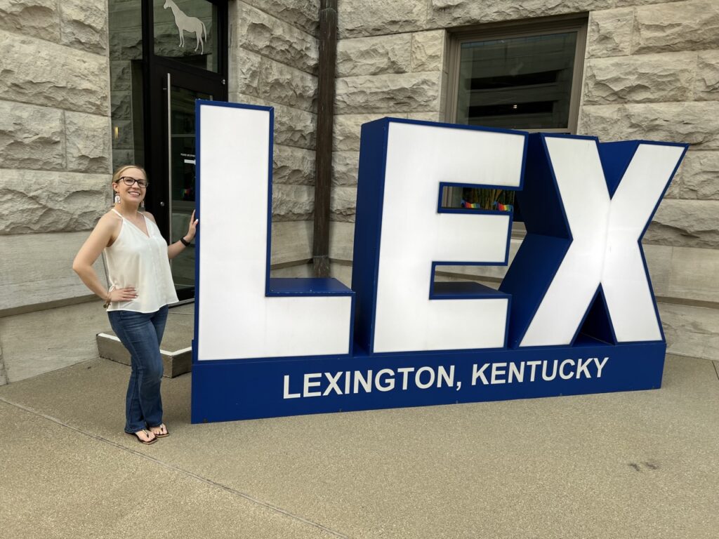 Me standing next to a sign that says LEX