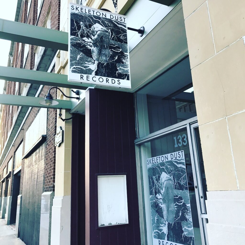 Skeleton Dust Records sign in front of their current 3rd Street location in Dayton, Ohio